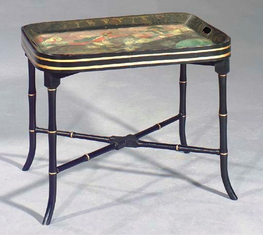 AN ENGLISH BLACK AND POLYCHROME-PAINTED TOLE TRAY ON LATER FAUX BAMBOO STAND,