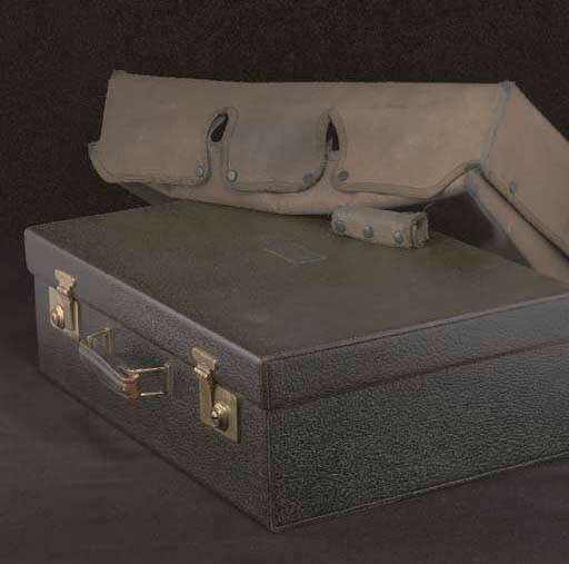 A DARK GREEN LEATHER CASE BY CARTIER