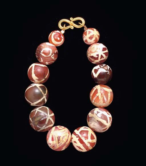 A WESTERN ASIATIC ETCHED CARNELIAN BEAD BRACELET