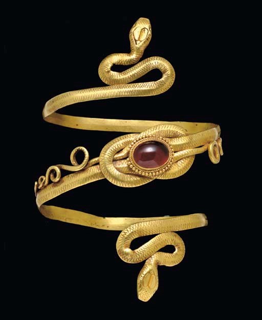 A GREEK GOLD AND GARNET SNAKE ARMBAND