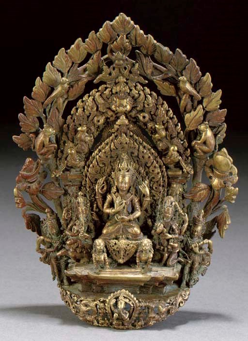 A Tibetan gilt copper model of Buddhist dieties, 17th/18th Century