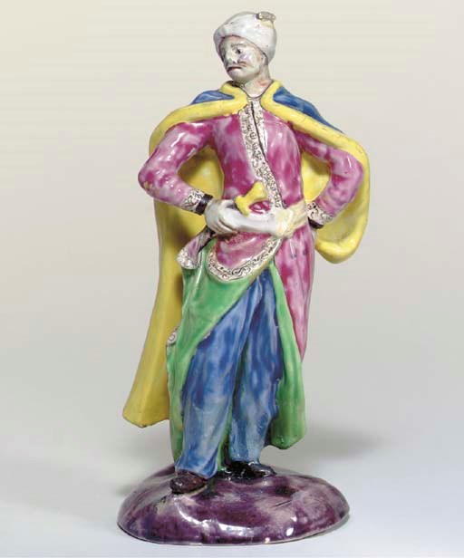 AN ENGLISH ENAMELLED SALTGLAZED MODEL OF A MAN IN TURKISH COSTUME