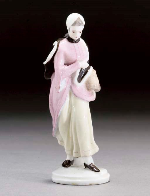 A ZÜRICH (SOFT-PASTE) FIGURE OF A LADY WITH A MUFF