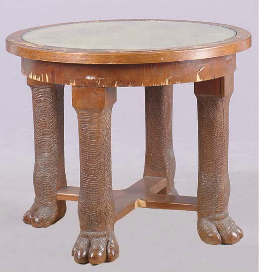 A COLONIAL OAK CIRCULAR CENTER TABLE WITH ELEPHANT CARVED LEGS,