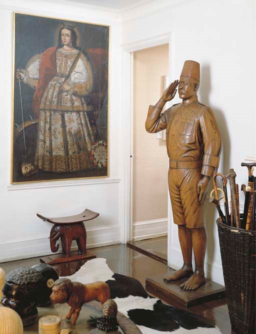 A FRENCH COLONIAL CARVED WOOD FIGURE OF A GENDARME,