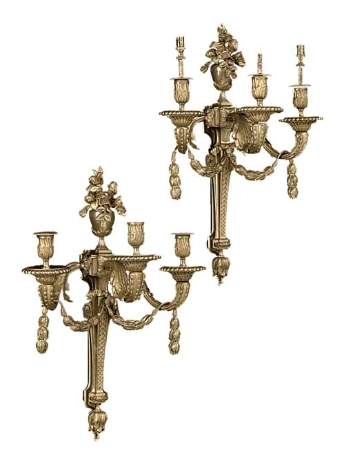 A pair of Louis XVI style ormolu three-light wall appliques
