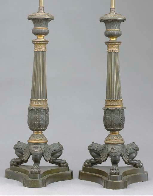 A PAIR OF LOUIS PHILIPPE GILT AND PATINATED BRONZE CANDLESTICKS MOUNTED AS LAMPS,