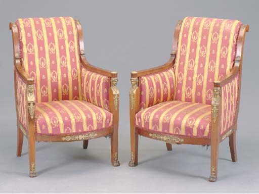 A PAIR OF EMPIRE MAHOGANY PARCEL GILT AND ORMOLU MOUNTED BERGERES,