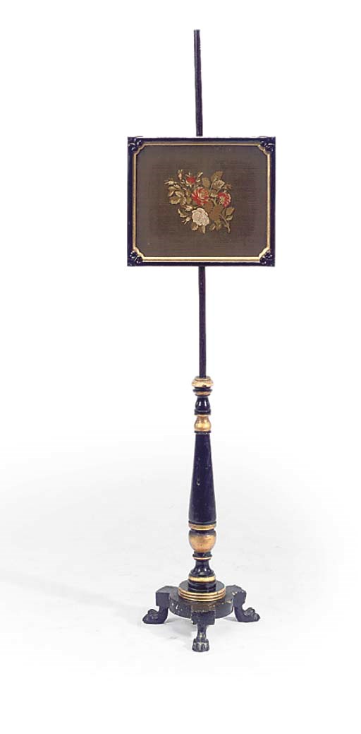 AN EARLY VICTORIAN PARCEL-GILT AND EBONISED POLE SCREEN