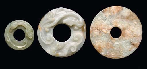 A Chinese mottled celadon and russet jade bi disc, 18th/19th century