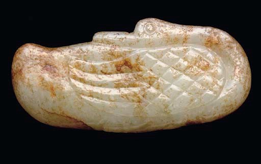 A Chinese mottled celadon and russet carving of a duck, 17th century