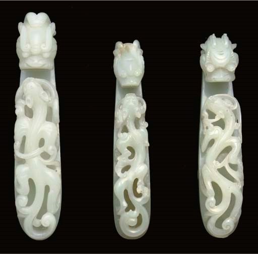 Three pale celadon jade belthooks, 19th century
