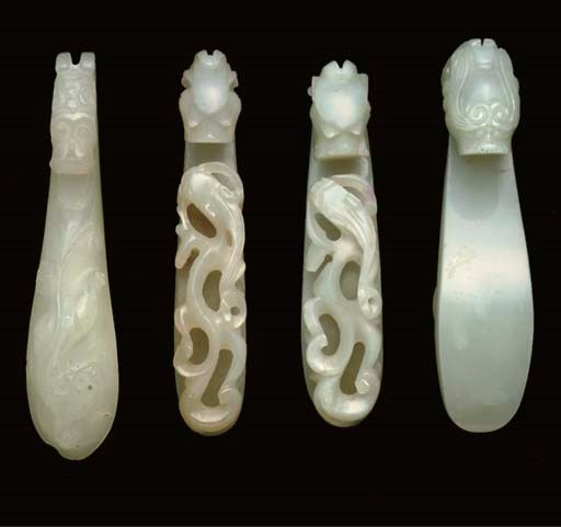 Four Chinese pale celdadon jade belthooks, 19th century