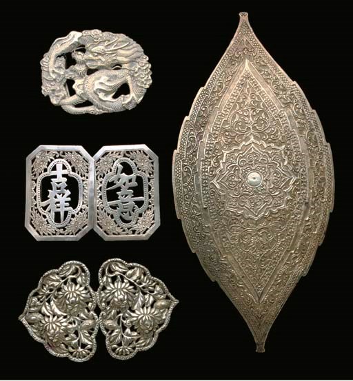 A quantity of Chinese, Japanese and Middle Eastern white metal belt buckles, belt and clasps, 19th/20th century