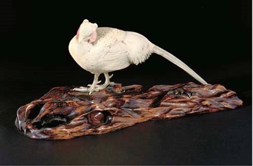 A Japanese partially stained ivory okimono of a pheasant, Meiji Period