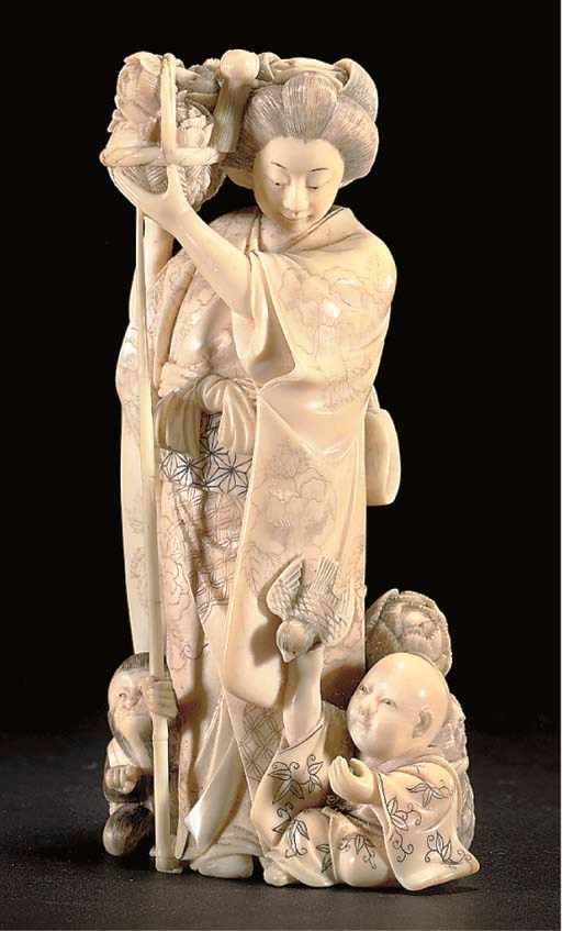 A Japanese ivory okimono of a lady with monkey and child, 19th Century