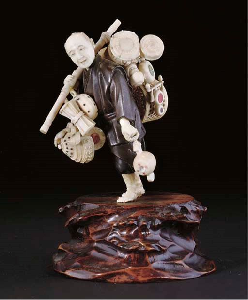 A Japanese ivory and bronze okimono of a basket seller, Meiji Period