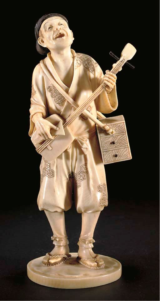 A Japanese ivory okimono of a samisen player, 19th Century