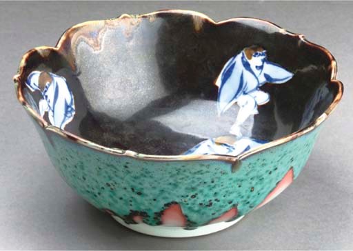 A Japanese Kozan underglaze blue and enamelled foliate rimmed bowl, underglaze blue signature, Meiji period