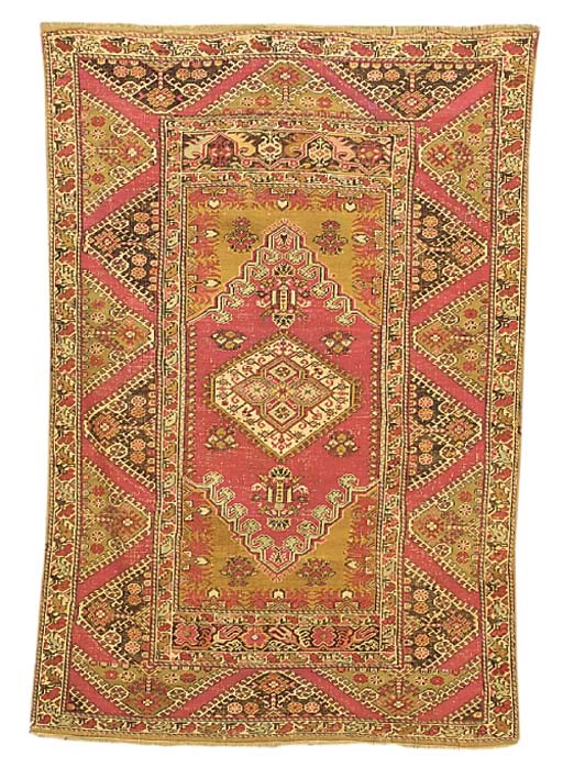 An antique Ghiordes rug