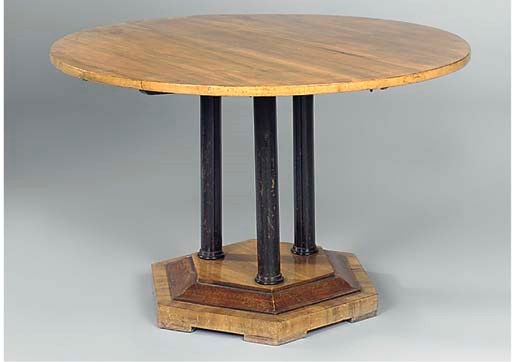 AN AUSTRIAN WALNUT AND EBONISED CIRCULAR DINING TABLE