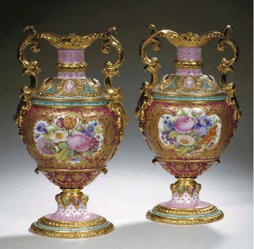 A pair of French porcelain two-handled heavily gilt floral presentation vases