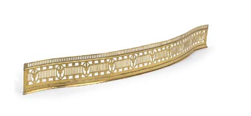 A GEORGE III BRASS SERPENTINE FENDER
