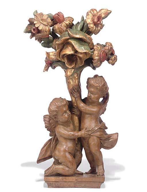 A FLEMISH OAK GROUP OF TWO PUTTI SUPPORTING A CORNUCOPIA