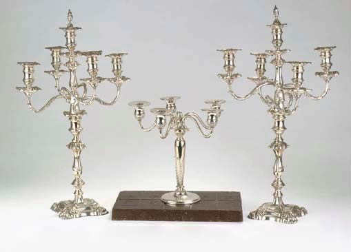 An English silver pair of five-light candelabra and a German silver five-ligth candelabrum