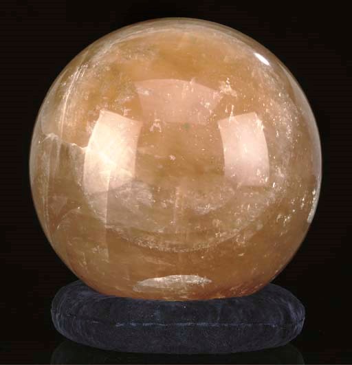 A large orange calcite sphere,