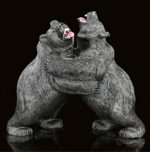 An obsidian carving of two bears fighting,