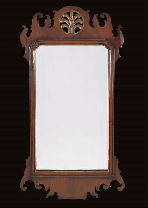 A MAHOGANY AND PARCEL GILT FRET CARVED MIRROR