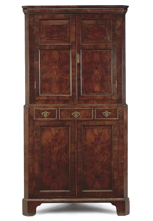A WALNUT CORNER CUPBOARD