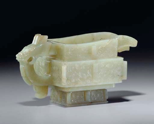 AN ARCHAISTIC GREENISH-BROWN JADE POURING VESSEL