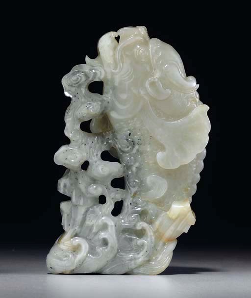 A WHITE AND GREY JADE CARP-FORM VASE