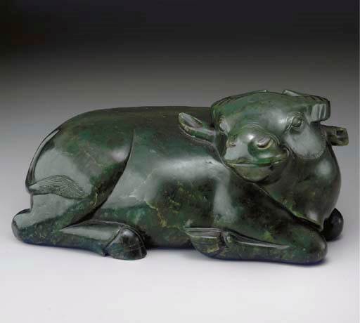 A DARK GREEN JADE FIGURE OF A RECUMBENT BUFFALO