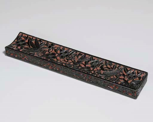 A RARE CARVED BLACKISH-BROWN AND RED LACQUER SCROLL TRAY