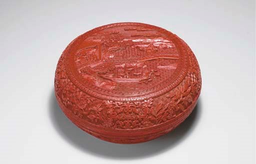 AN UNUSUAL CARVED RED LACQUER CIRCULAR BOX AND COVER