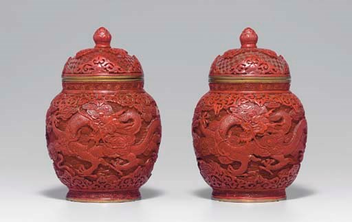 A PAIR OF CARVED RED LACQUER OVOID JARS AND COVERS