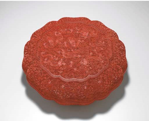 A LARGE CARVED RED LACQUER PETAL-LOBED BOX AND COVER
