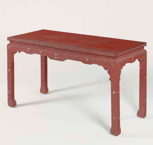 A RED LACQUER CORNER-LEG TABLE