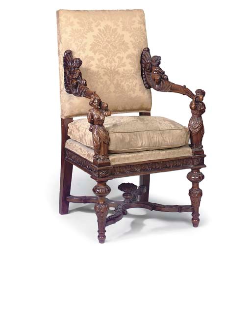 AN ITALIAN WALNUT AND UPHOLSTERD ARMCHAIR