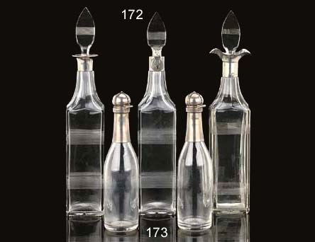 A GROUP OF THREE SILVER MOUNTED GLASS DECANTERS