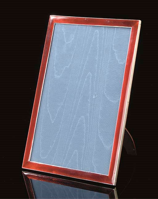 A SILVER-MOUNTED RED ENAMEL PHOTOGRAPH FRAME