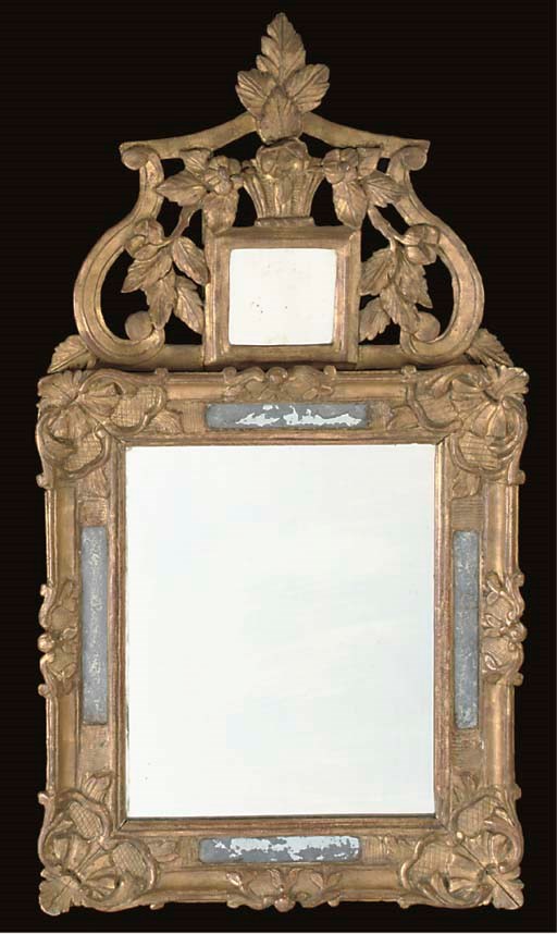 A LOUIS XV CARVED GILTWOOD MIRROR