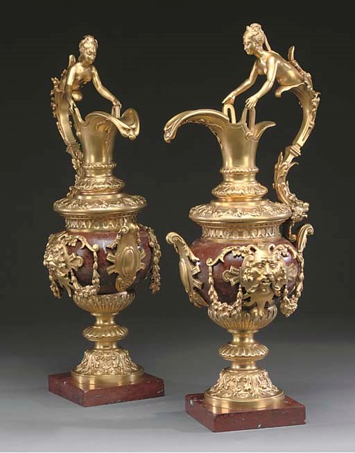 A PAIR OF GILT BRONZE MOUNTED ROUGE MARBLE ORNAMENTAL EWERS