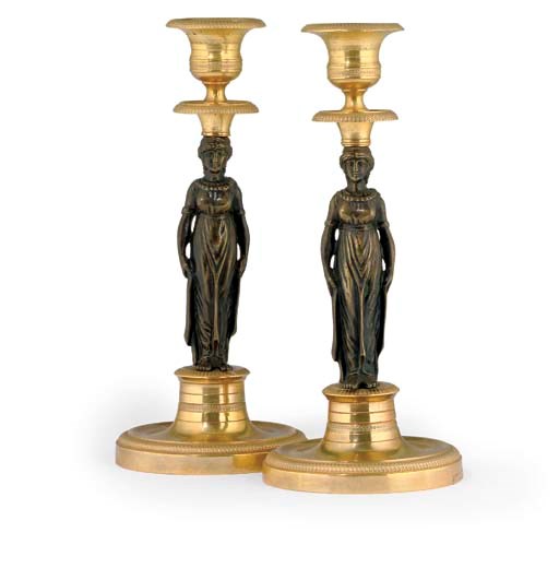 A PAIR OF EMPIRE BRONZE AND ORMOLU CANDLESTICKS
