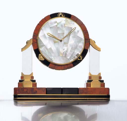 CARTIER. A LIMITED EDITION GILT-METAL, ONYX, HARDSTONE, MOTHER-OF-PEARL AND ENAMEL DESK CLOCK