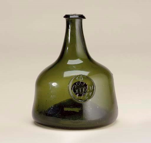 AN ENGLISH OLIVE-GREEN TINTED GLASS SEALED WINE BOTTLE
