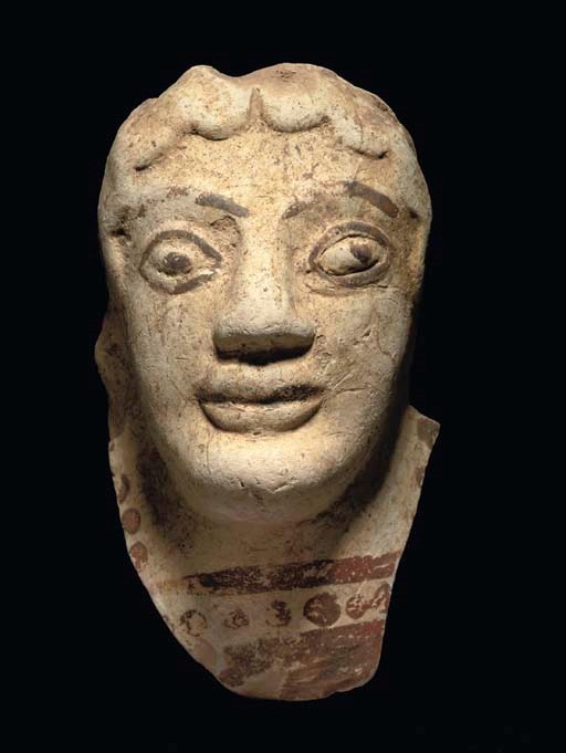 A GREEK TERRACOTTA FEMALE HEAD